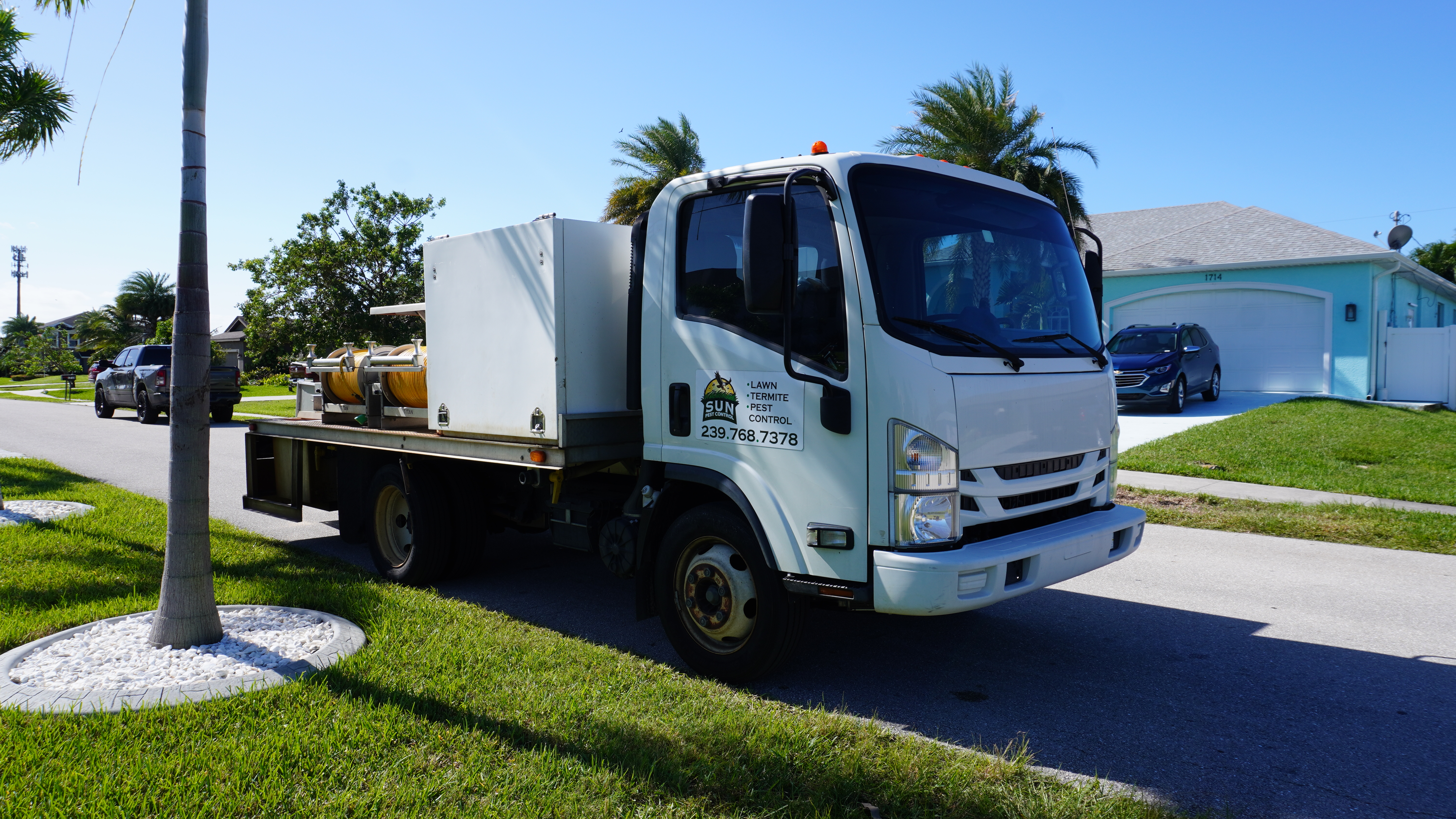 Sun Pest Control service truck arriving at a home in Southwest Florida
